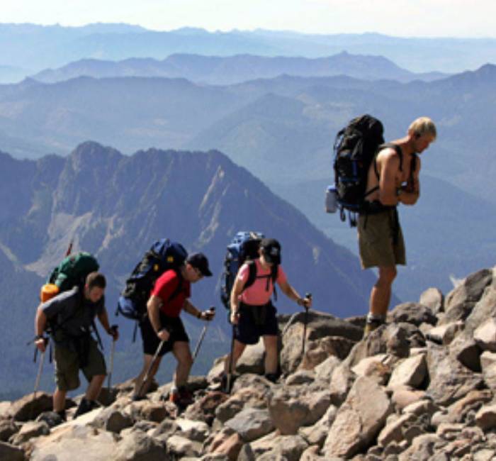 Hikers making their way across rocky mountain terrain