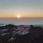 Mountain sunrise above cloud layer