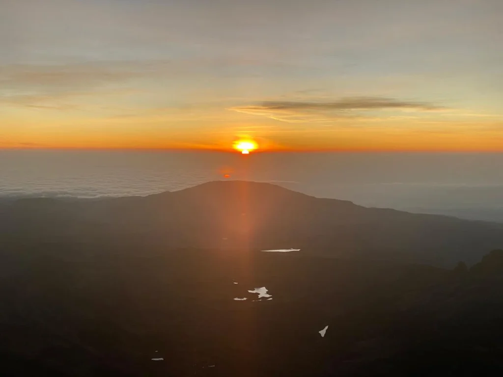 Sunrise above clouds and hills